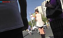 חמודה ארוכת רגליים בלבן מציגה את רגליה הדקות בתחנת אוטובוס