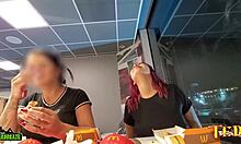 2人の性的に興奮した女性が、マクドナルドで食事をしながら胸を露出しています - プロの刺青入りの天使が登場します。